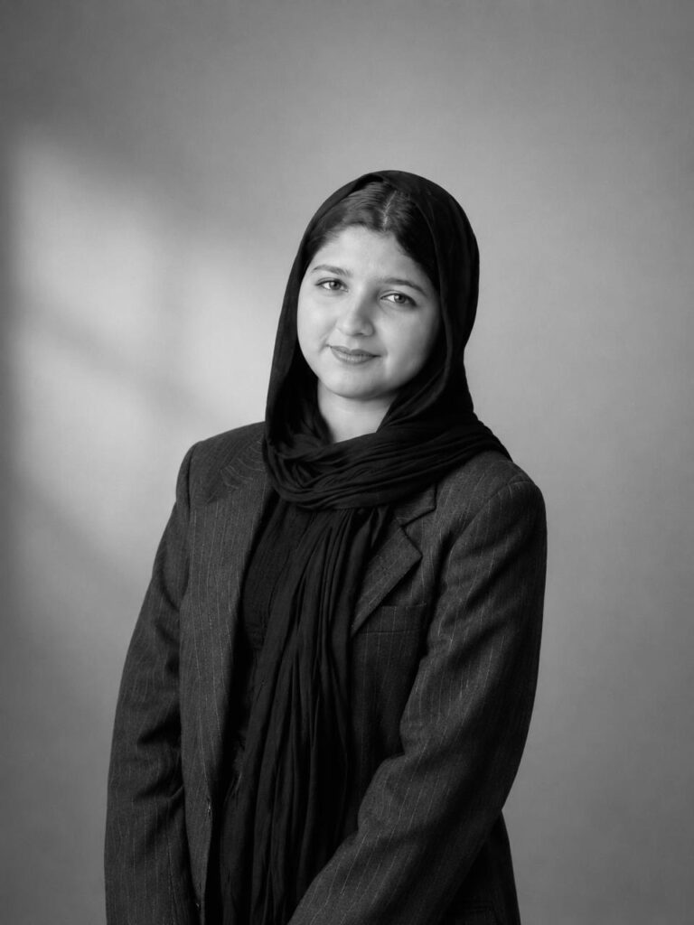 Professional portrait of Shifna, a digital marketing specialist wearing a black blazer and hijab, representing SEO, social media marketing, SEM, content marketing, email marketing, and web development services.